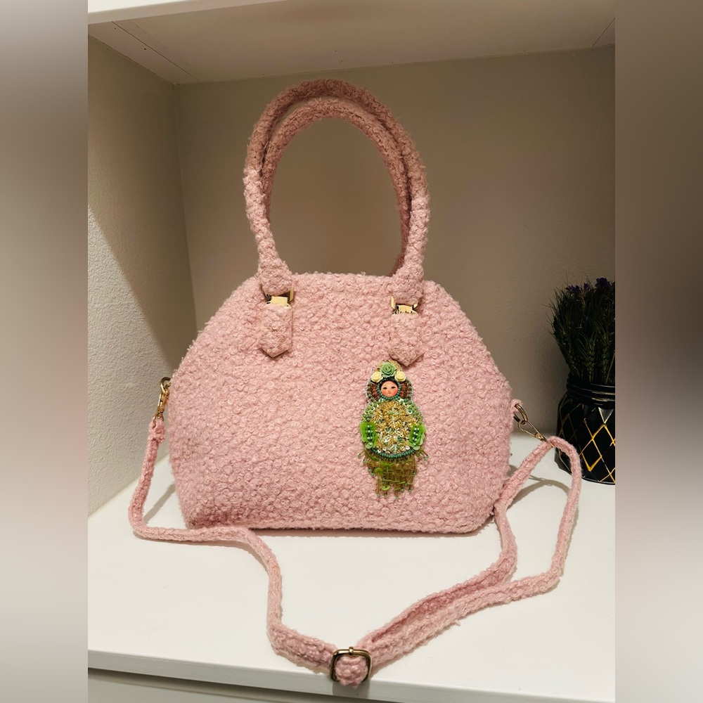 Custom handmade handbag and Matryoshka brooch by the designer.